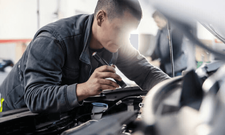 Man checking hood of car