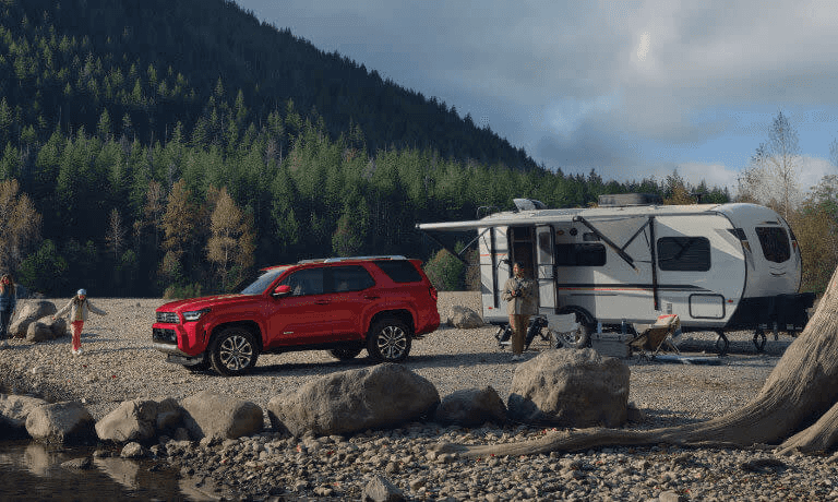 A car outside near a camper