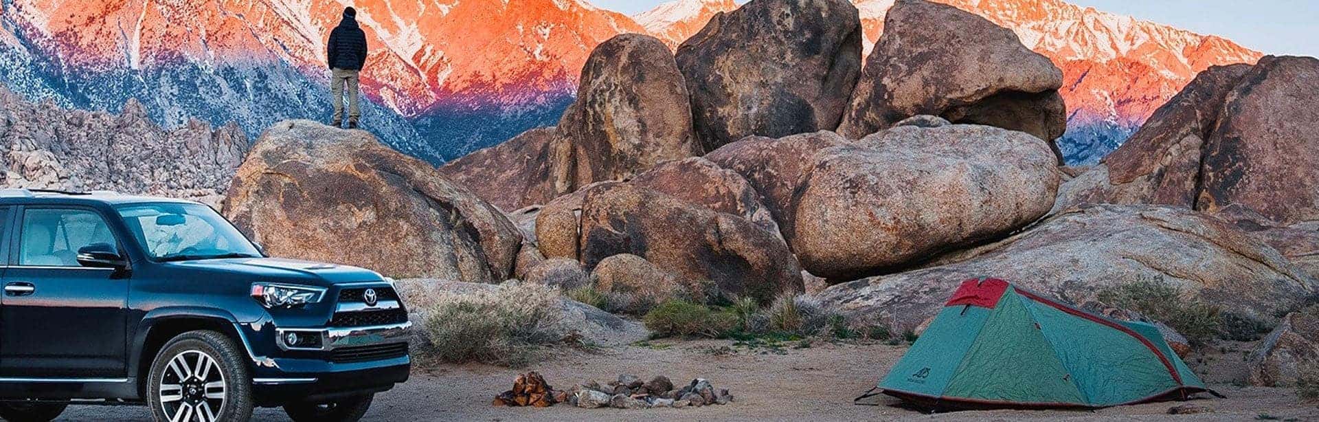 Man-views-colorful-mountains-with-Toyota-desktop