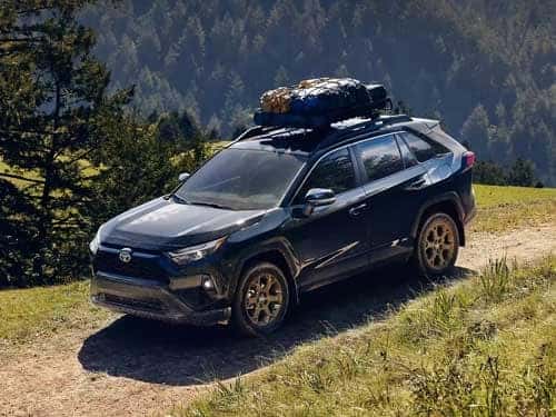 2023-rav4-hybrid-driving-on-a-dirt-path