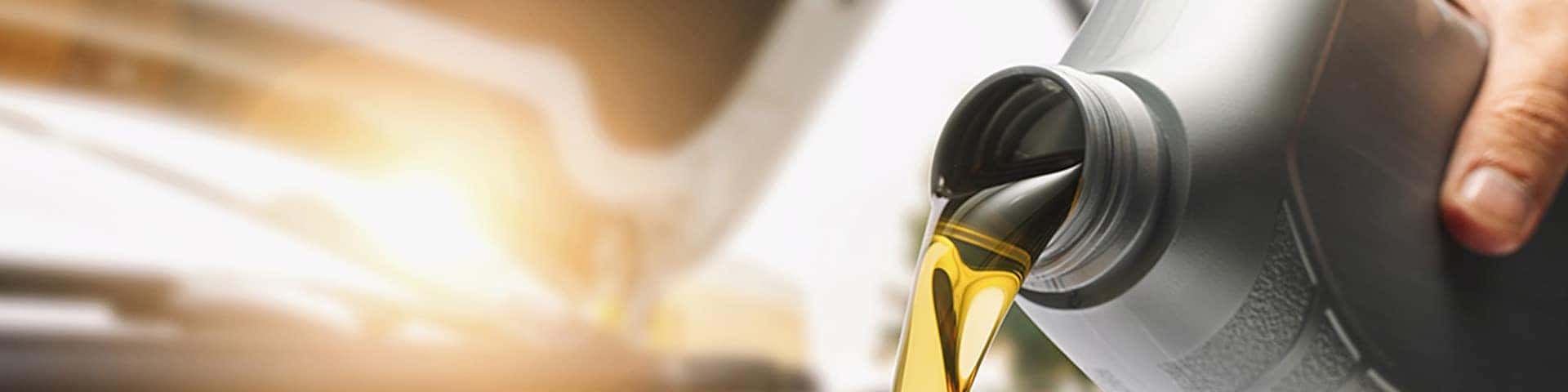 Close up view of oil being poured from a bottle