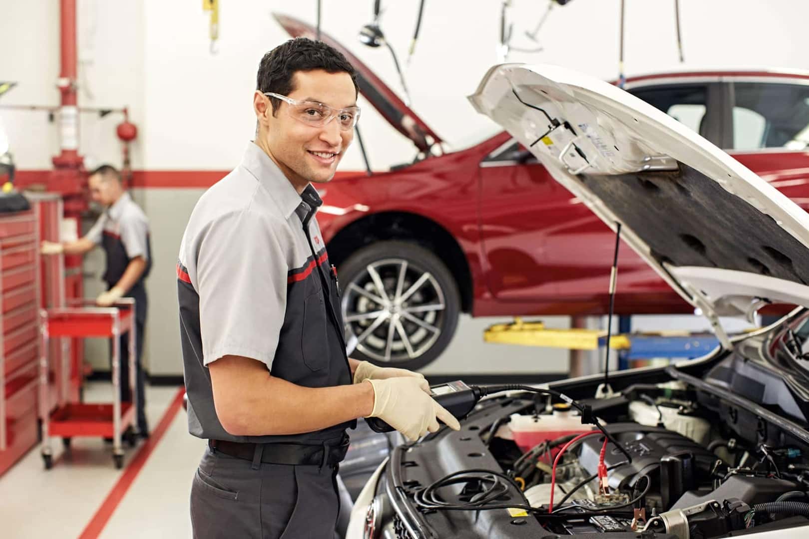 toyota technician checks engine in service bay