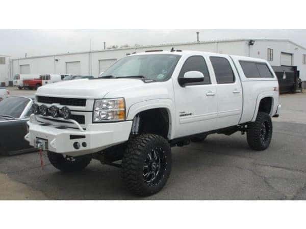 dungeon-garage-slider-6-mobile white lifted chevy 1500 with custom grill mounted flood lights