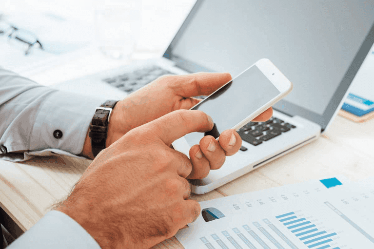 man calculates finances with smartphone