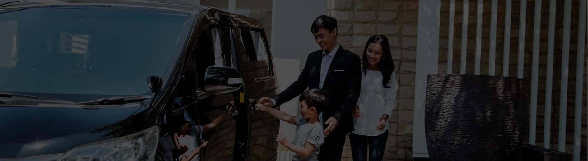 Happy family walking to their new car