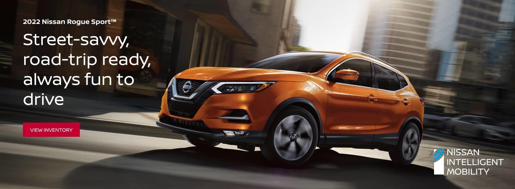 Orange-2022-Nissan-Rogue-Sport-driving-down-busy-road