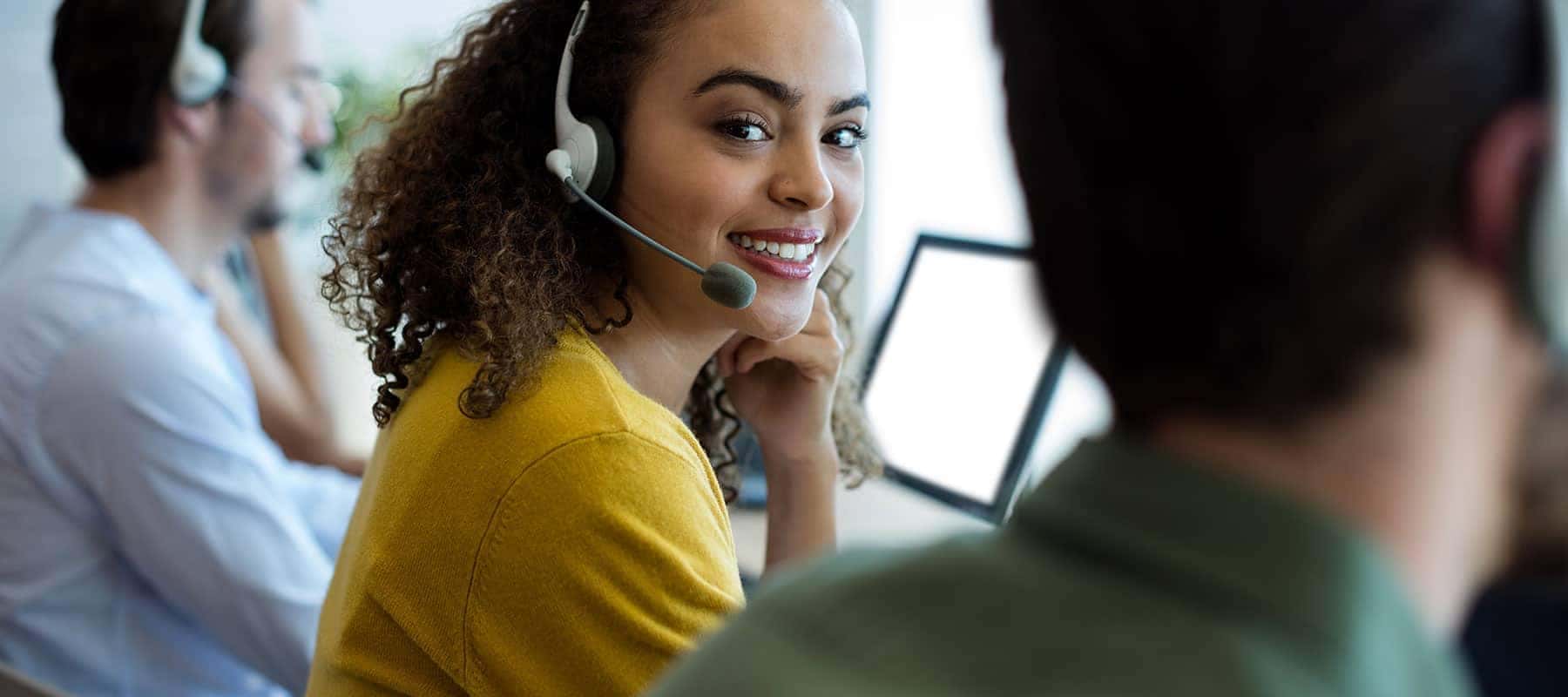 customer service rep answers call in her headset