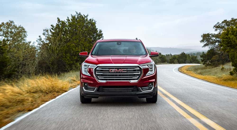 Red 2022 GMC Terrain rounding a corner