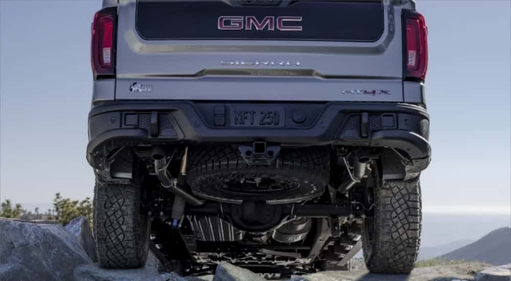 Silver 2024 GMC Sierra 1500 AT4X AEV Edition parked off-road