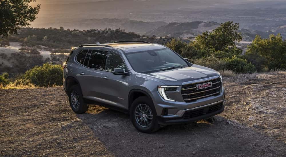 A silver 2025 GMC Acadia Elevation parked off-road