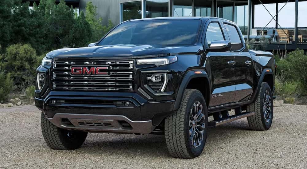 Black 2026 GMC Canyon parked off-road on gravel