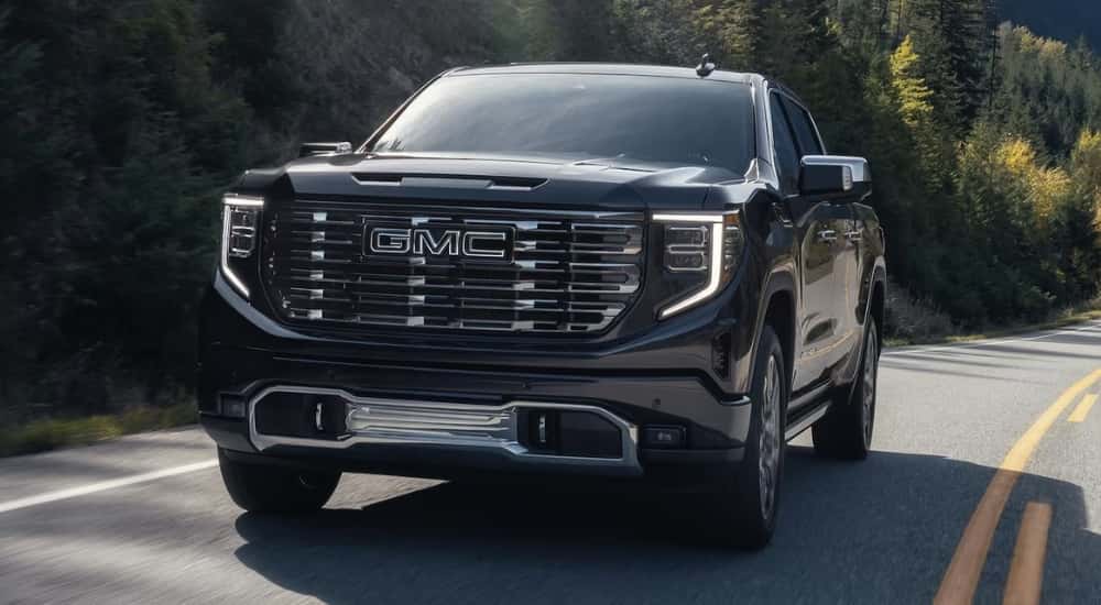 Black 2026 GMC Sierra 1500 for sale near Champaign rounding a corner on a test drive