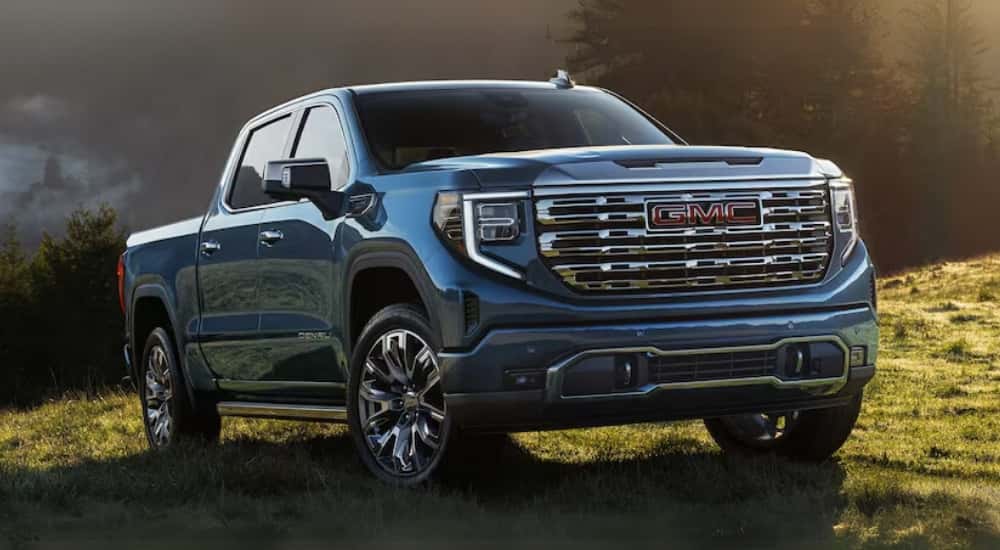 Blue 2026 GMC Sierra 1500 parked on a grassy knoll