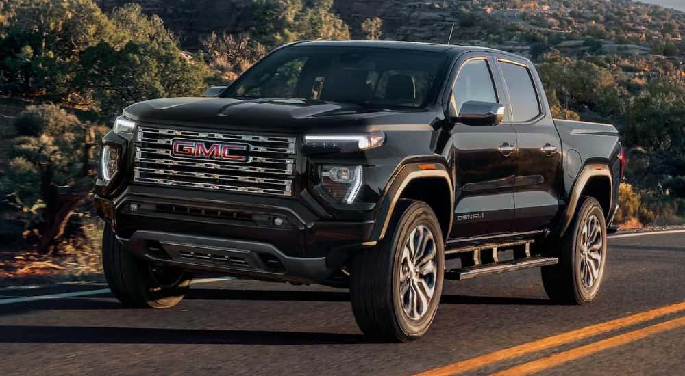Black 2026 GMC Canyon Denali driving on a highway