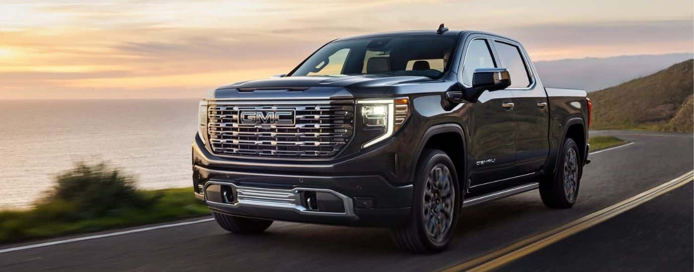 Black 2023 GMC Sierra 1500 for sale driving on a highway