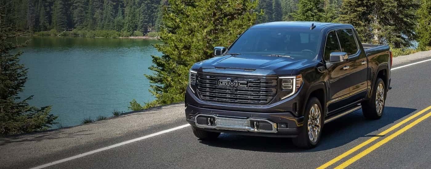 Black 2024 GMC Sierra 1500 Denali driving to a used GMC dealer