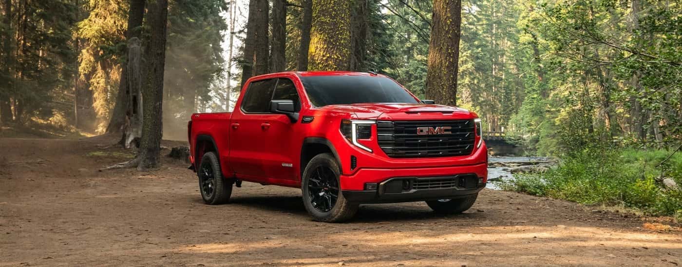 Red 2026 GMC Sierra 1500 Elevation parked off-road