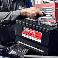 ford-technician-looks-at battery