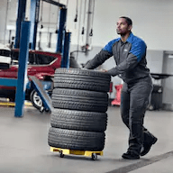 technician-moving-tires