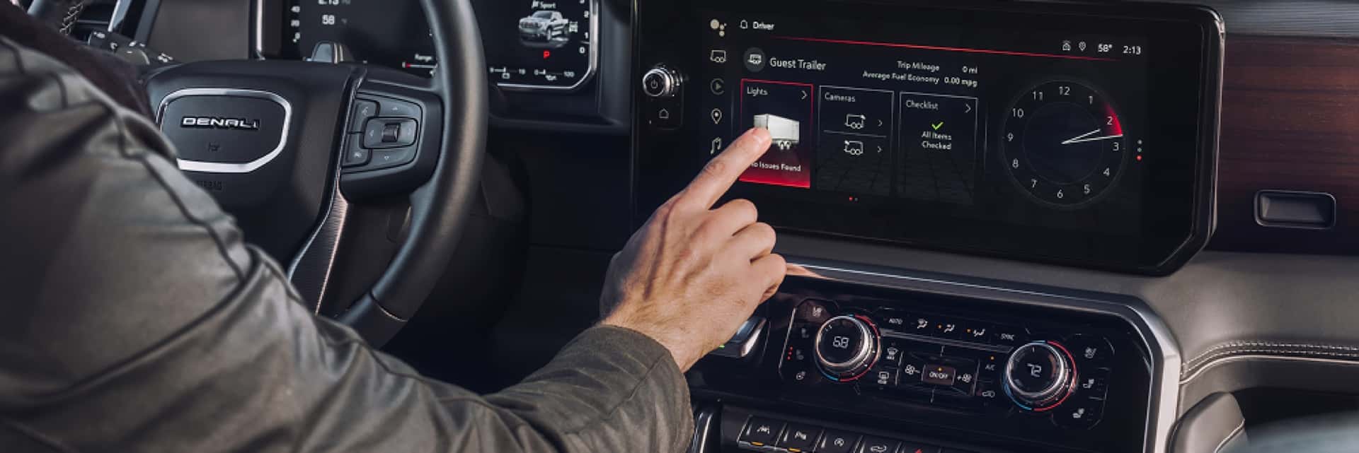 GMC-Denali-truck-interior-with-driver-pushing-buttons-on-the-middle-console