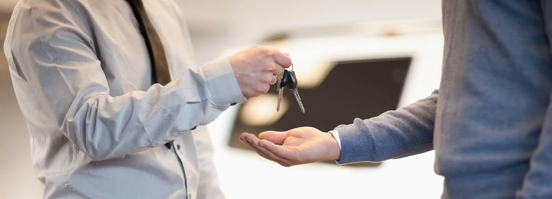 men exchanging car keys