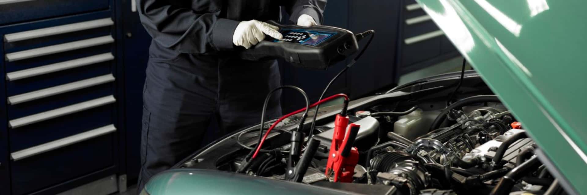 Honda-service-technician-checking-on-the-voltage-level-of-car-engine