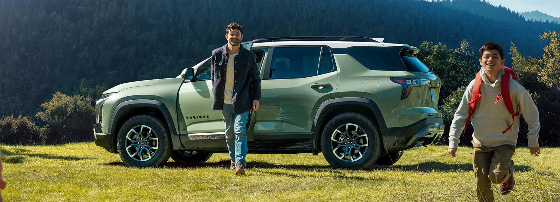 2025-equinox-parked-with-man-and-boy-running
