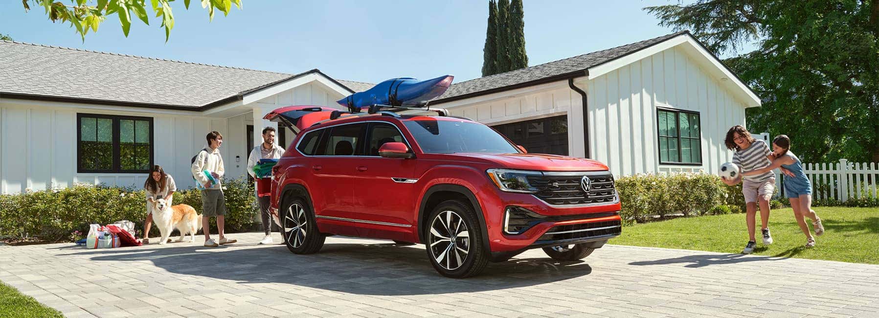 2024-Red-Atlas-in-a-driveway-with-a-family