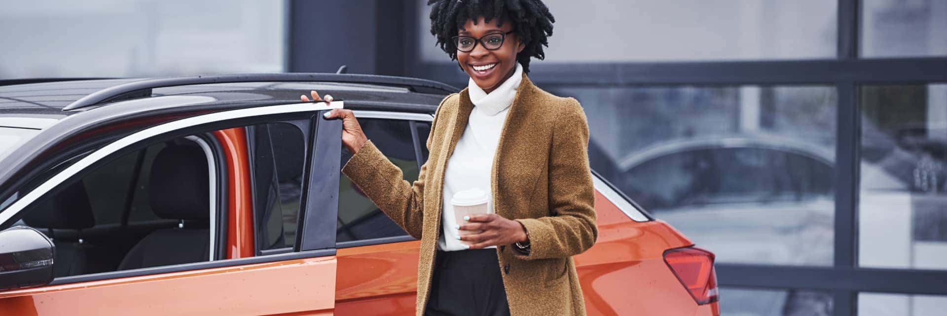 woman-happy-with-orange-vehicle