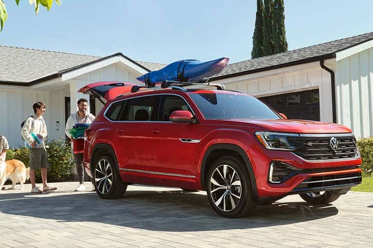 2024-Red-Atlas-in-a-driveway-with-a-family