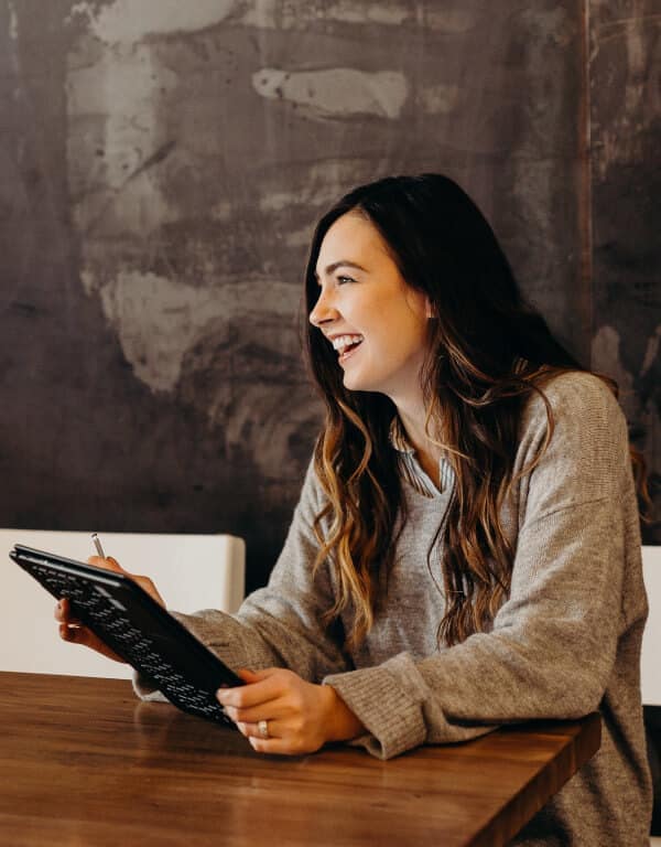Woman smiling with a tablet
