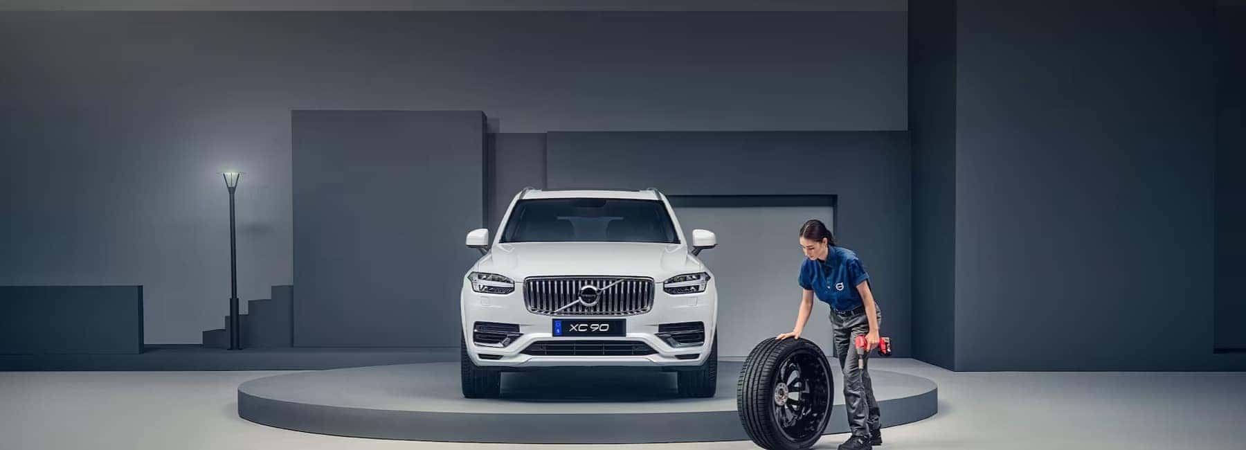 volvo-technician-rolls-tire-to-replace-on-XC90