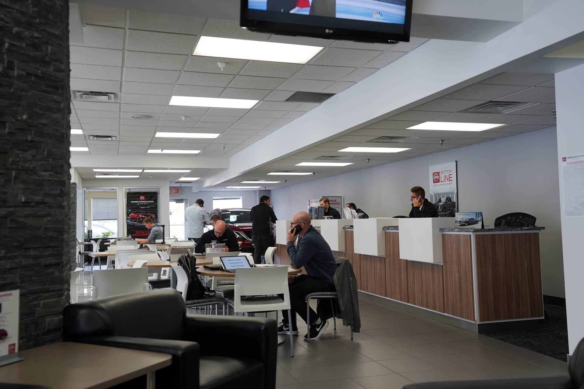 people inside of the dealership talking on the phone