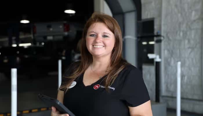 Vehicle Service Advisor in front of UVEye Machine