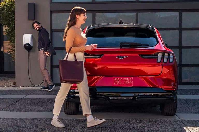 Woman walking behind Mustang EV
