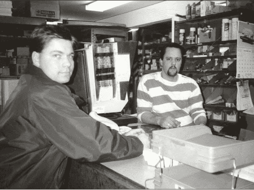 A couple of men at a cash register