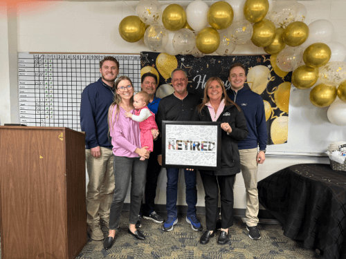 A group of people standing in front of a podium holding a sign