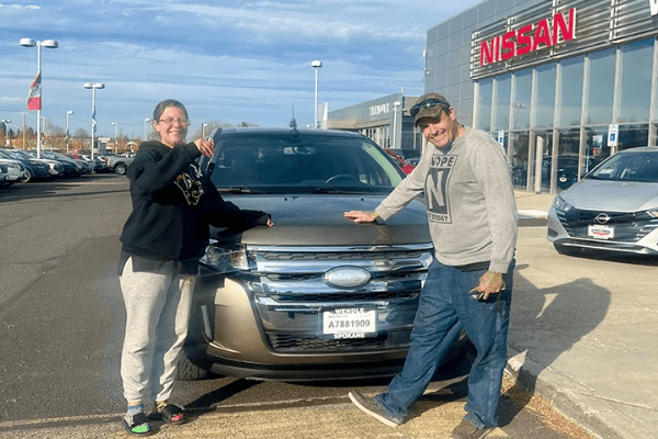 Customer in front of purchased car