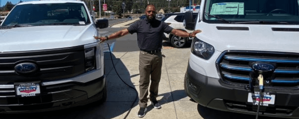A person standing next to a car