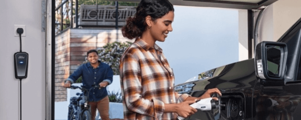 A person charging a car
