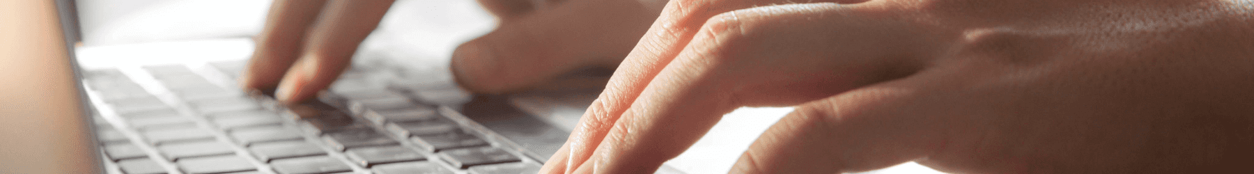 Hands typing on a keyboard