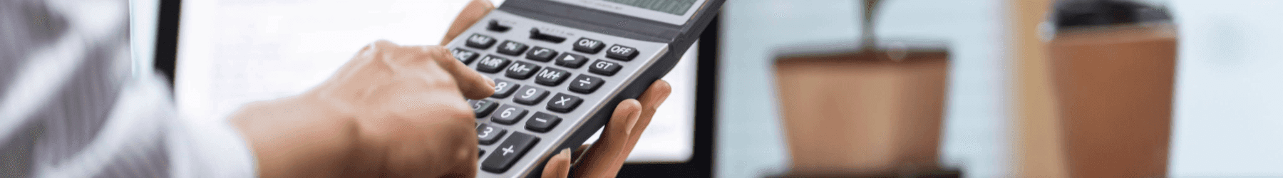 A hand holding a calculator