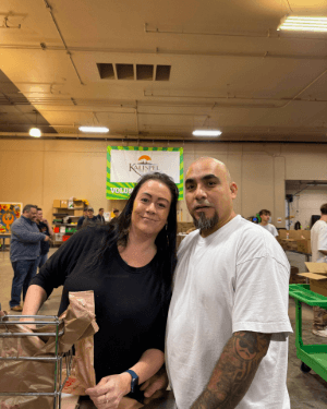 Two people standing together in a warehouse