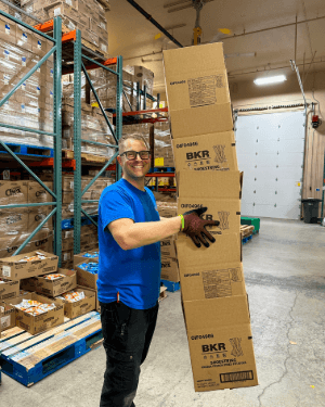 A person holding a bag in a warehouse