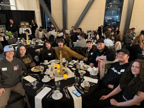 A group of people sitting around a table
