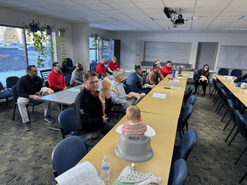 A group of people sitting at long table