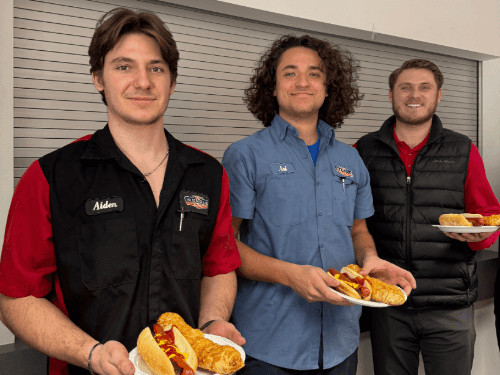 A group of men holding plates of food