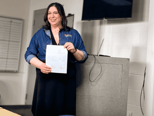 A person holding a piece of paper