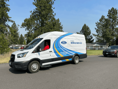 A white van driving on a street