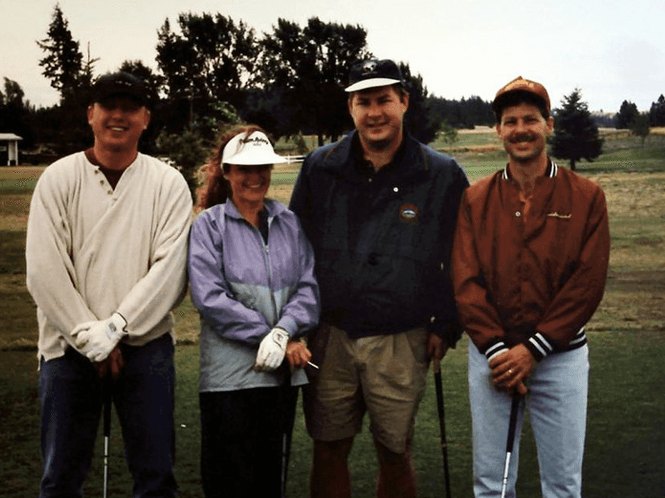 A group of people standing on grass